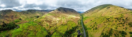 Panorama of Mountains over road A591 from a drone, Grasmere Lake, Grasmere, Ambleside, Lake