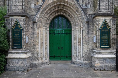 Neo-Gothic church entrance with green door, St James's Church, Norlands, architects Lewis Vulliamy,