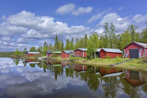 Traditional red wooden boat houses, boathouses at Lake Ånnsjön, Jämtland County, western Sweden,