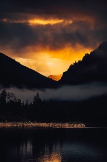 Surreal light atmosphere at sunrise at Plansee, Tyrol, in the Alps in Austria