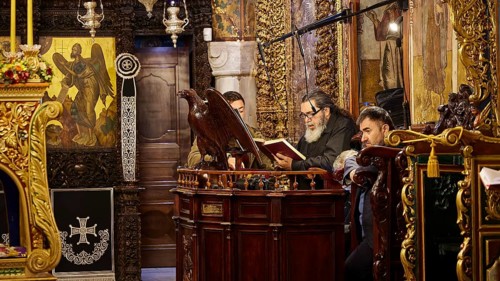 Men reading from religious books in a church decorated with icons, Holy Week, Bay of Panormitis,
