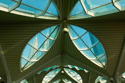 Petronas twin towers viewed through glass roofs of As Syakirin Mosque or KLCC Mosque, Kuala Lumpur,