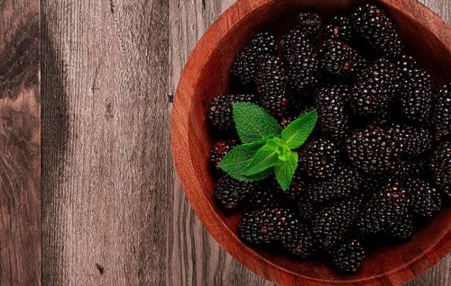 Blackberries, in a wooden bowl, top view, no people