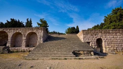 Stone staircase leads to ancient ruins, surrounded by sky and nature, open staircase to the second