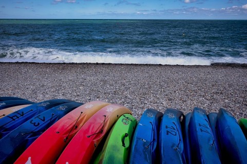 Kayaks, boats, colourful, lying on the beach, pebble beach, Étretat, sea, Normandy, Seine-Maritime,