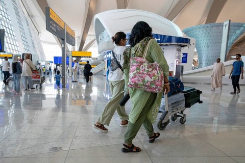 Airport Women with luggage, Abu Dhabi, United Arab Emirates
