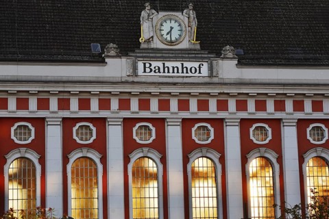 Hamm main station, façade with station clock and sculptures of a wire-drawer and a miner at the