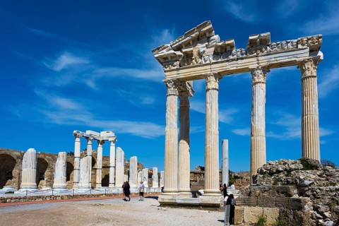 Ruined temple with majestic columns under a clear sky. Historical atmosphere in ancient Greek