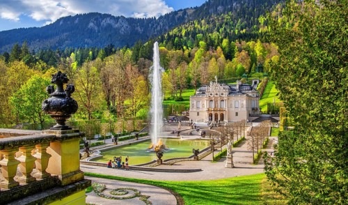 Water parterre with large fountain and portal of Linderhof Castle in spring, municipality of Ettal,