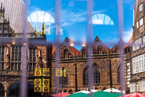 Cherry nave of the Church of Our Lady, Town Hall and German House Market (right) reflected in the