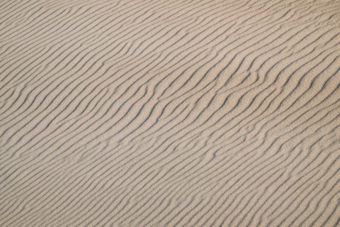 Natural sand patterns with wave-like grooves on a dune, beach near Hvide Sande, North Sea, Denmark