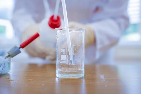 Close-up of a beaker with liquid and pipette in the laboratory, Battery Research, Nagold, Germany