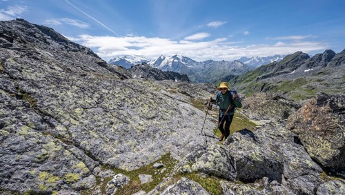 Mountaineer in rocky mountain landscape at the Col du Louvie, view of the summit of the Grand