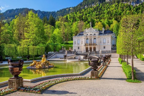 Water parterre with flora fountain and the portal of Linderhof Castle in spring, municipality of