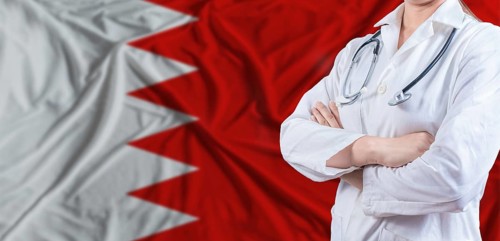 Doctor with crossed arms on Bahrain flag. Bahrain health and care concept. Female doctor on Bahrain