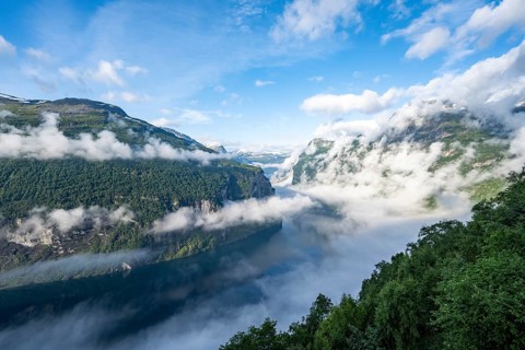 View over the Geirangerfjord, atmospheric clouds over the fjord in the morning light, Ørnesvingen