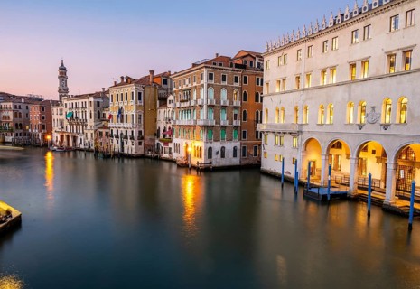 View of the Grand Canal at sunset, picturesque evening mood with illuminated palazzos on the canal