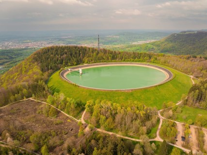 Upper reservoir, landscape with reservoir and forest on a hill, observation tower in the