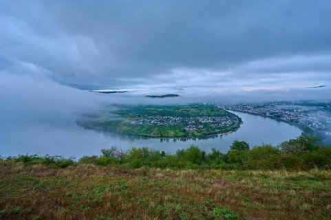 River in morning mood under cloudy sky, slightly shrouded in haze, summer, Rhine bend Boppard,