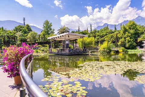 Idyllic park with pond, pavilion and mountains in the background, Botanical Garden, The Gardens of