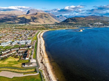 View of Caol Beach and Nevis Range Mountains from a drone, Corpach, Fort William, Highland,