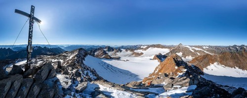 Mountain panorama at the Wilder Freiger summit with summit cross, picturesque high mountain