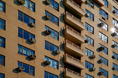 Brick façade of a high-rise building with air conditioning for the flats, New York City, USA
