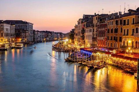 View of the Grand Canal at the blue hour, picturesque evening mood with illuminated palazzos on the