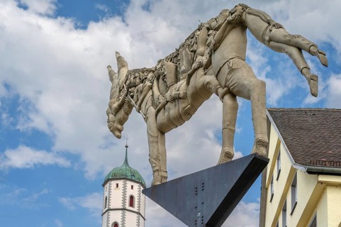 Monument: The trial of the donkey's shadow, created by the artist Peter Lenk, market square,