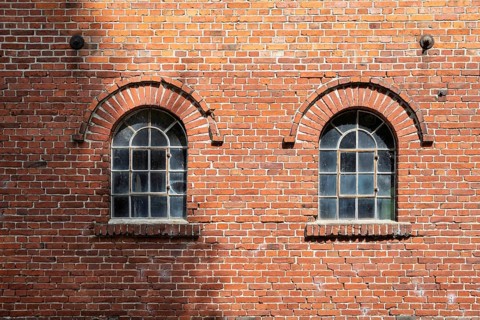 Old windows in a traditional brick wall with rustic charm and visible reflections, Stiftsmühle,