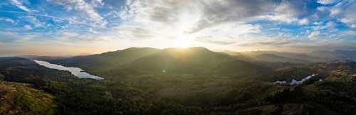 Panorama of Sunset over Mountains and Coniston Water from drone, Lake District National Park,