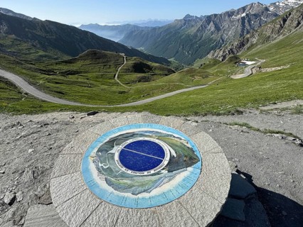 In front orientation board at viewpoint on third highest asphalted pass in the Alps highest border