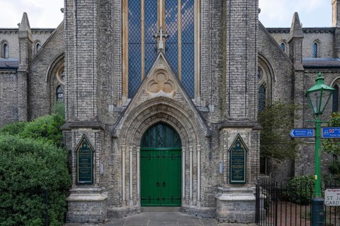 Neo-Gothic church entrance with green door, St James's Church, Norlands, architects Lewis Vulliamy,