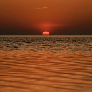 When the red sun sinks into the sea... Cuxhaven, North Sea, sunset in calm weather, glowing red