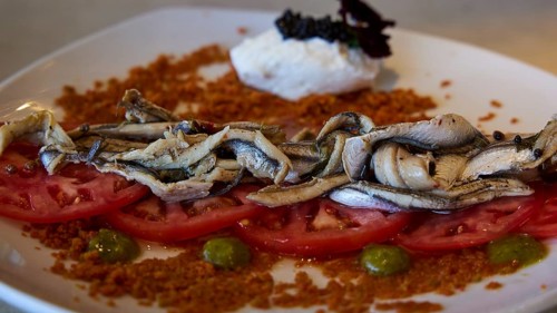 A plate of sardines on tomatoes, stylishly served with various ingredients, Stegna Beach, Stegna