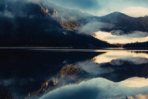 Sunrise with reflections in the Plansee in Tyrol in the Alps in Austria