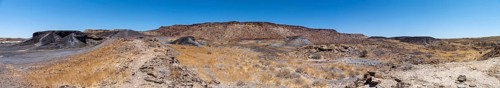 Dry landscape with yellow grass and black volcanic hills, Burnt Mountain, Damaraland, Kunene,