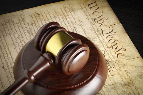 United states constitution and gavel resting on table