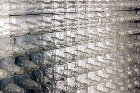 Wall of empty glass whiskey bottles at the Visitor Center of the Jack Daniel Distillery in
