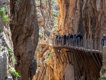 Tourists on the elevated path of the caminito del rey, along a deep gorge, Andalusia, Spain