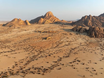 The isolated Spitzkoppe mountain (1728 m) majestically rises above the surrounding desert plains.