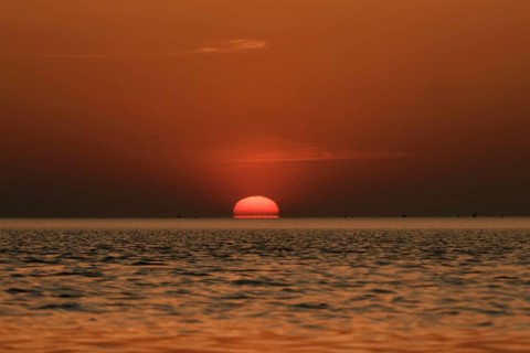 When the red sun sinks into the sea... Cuxhaven, North Sea, sunset in calm weather, glowing red
