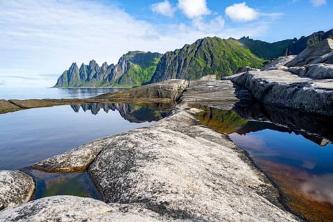 Reflection in a tidal pool, rocky coast of Tungeneset, Devil's Teeth, Okshornan, Ersfjorden, Senja