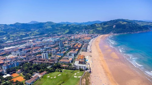 Aerial perspective of zarautz, gipuzkoa, showcasing the urban landscape meeting the sandy beach and