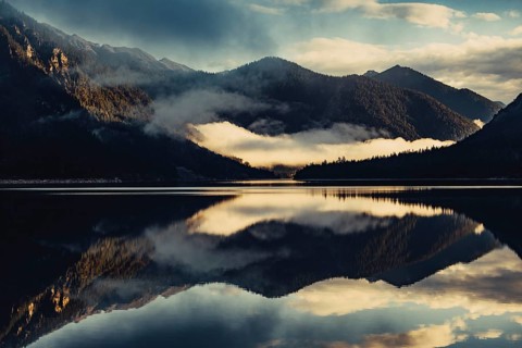 Sunrise with reflections in the Plansee in Tyrol in the Alps in Austria