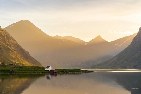 Landscape with sea and mountains on the Lofoten Islands. The fjord Flakstadpollen and some houses