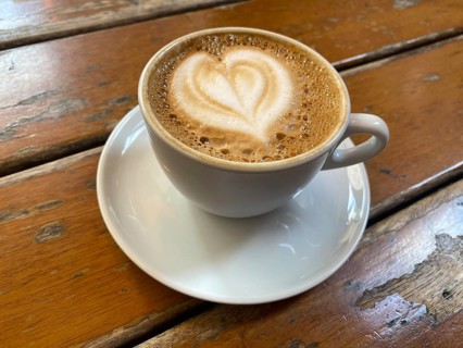 Cup of cappuccino, flat white, with heart-shaped milk foam, wooden table, Stuttgart,