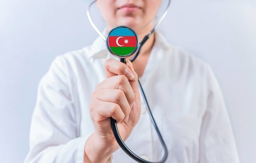 Female doctor holding stethoscope with Azerbaijan flag. National health system of Azerbaijan
