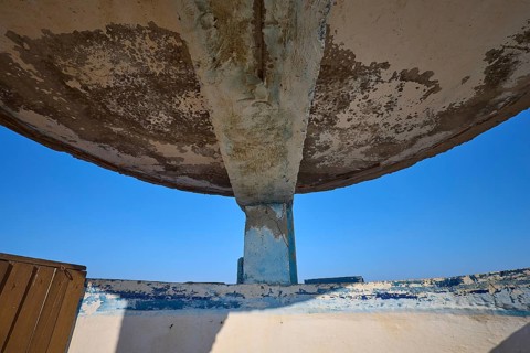 Dilapidated roof construction with concrete pillars and view of blue sky, Lost Place, Lago