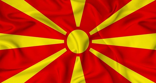 Realistic North Macedonia flag waving. Close up of flag of North Macedonia with cloth texture